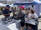 MADC volunteer working booth at an event.